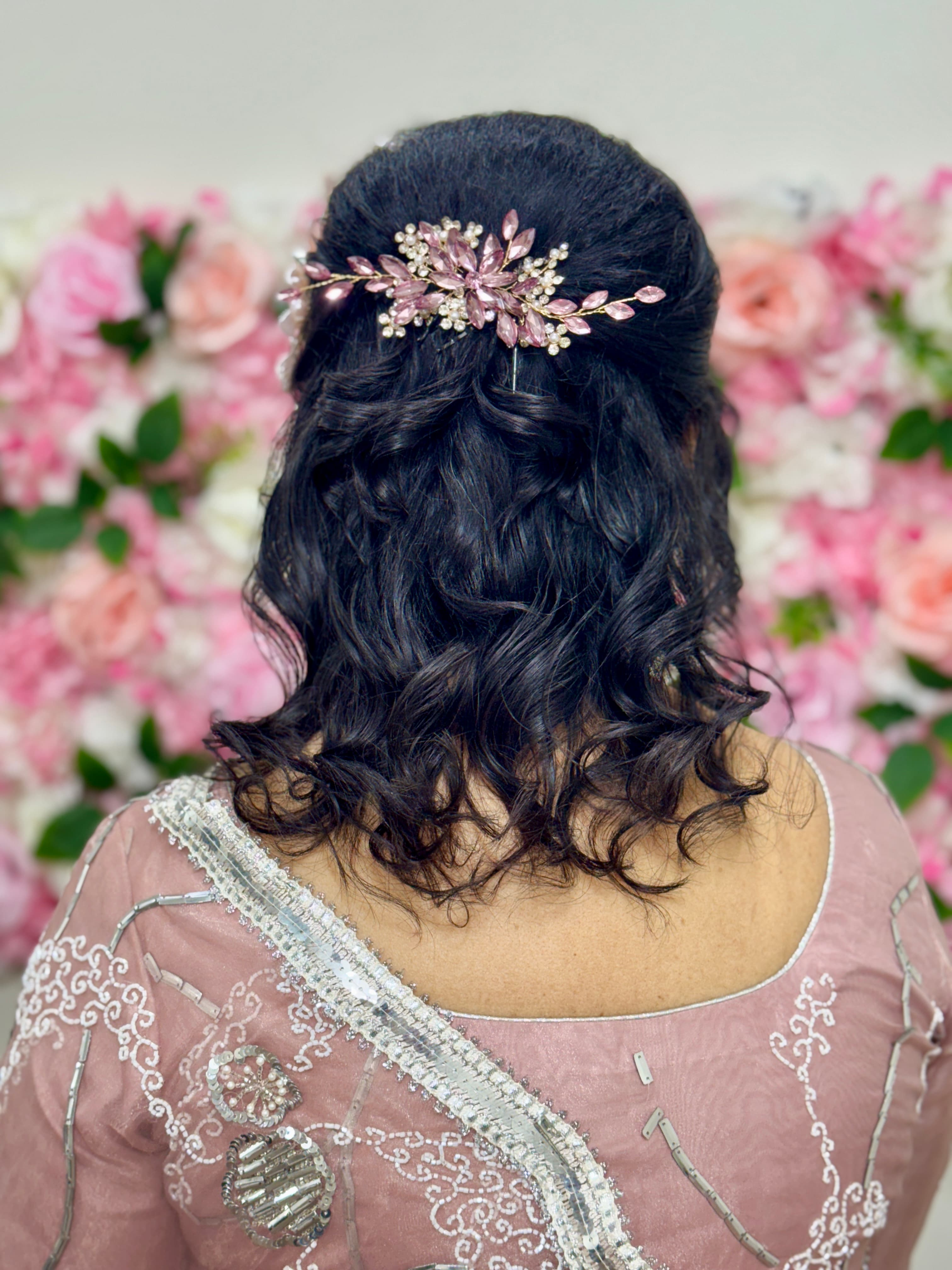 Half-up curls with rose gold floral pin